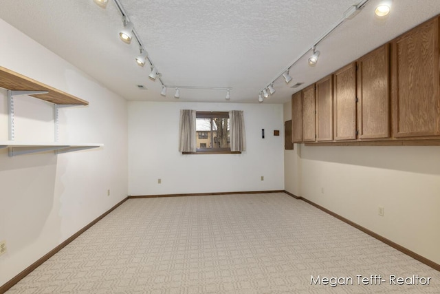 basement with a textured ceiling and light carpet