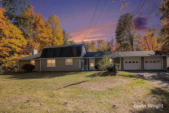 ranch-style home with a yard and a garage