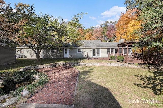 rear view of property featuring a pergola, a deck, and a yard