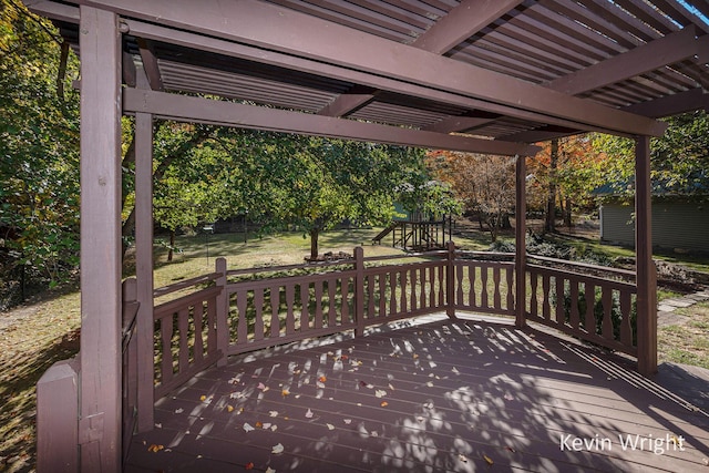 wooden deck with a yard and a playground