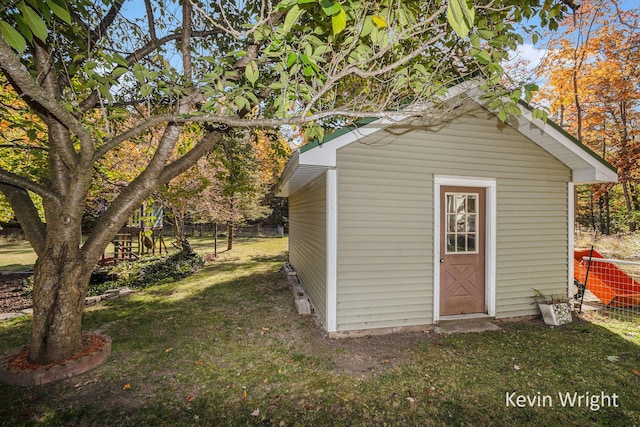 view of outbuilding with a yard