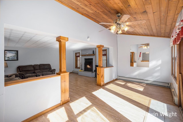 living room featuring wooden ceiling, vaulted ceiling, ornate columns, and a baseboard heating unit