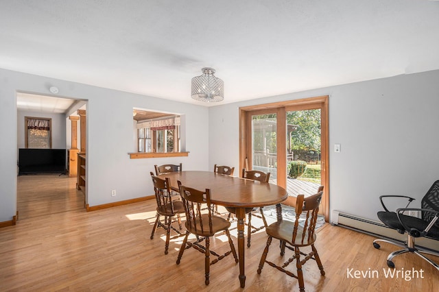 dining space with light wood-type flooring and a notable chandelier