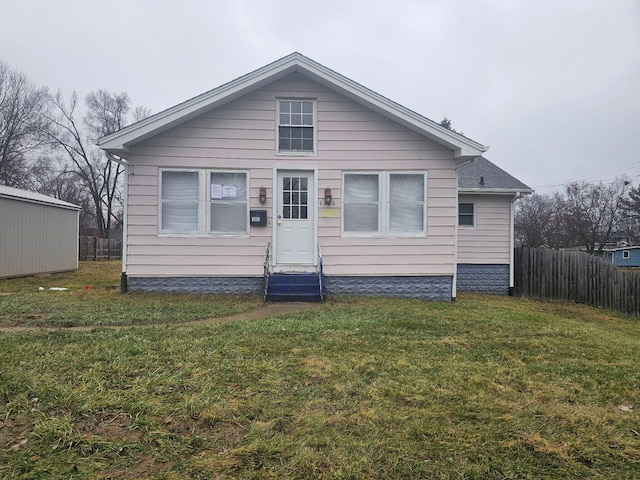 rear view of house featuring a yard