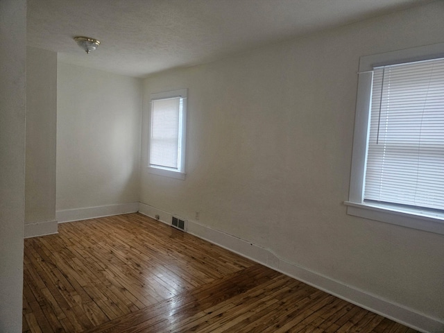 empty room featuring hardwood / wood-style flooring