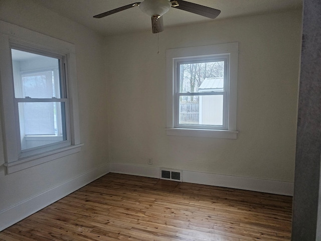 empty room with ceiling fan and light hardwood / wood-style floors