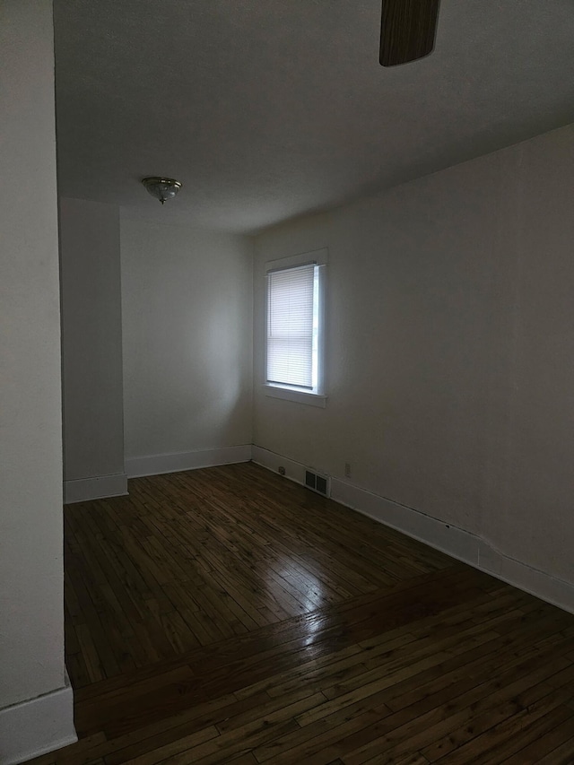 spare room with dark hardwood / wood-style floors