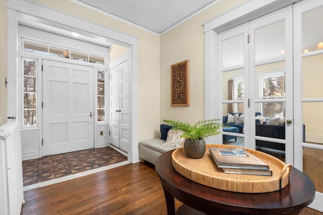 entrance foyer featuring ornamental molding and dark wood-type flooring