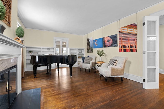 sitting room featuring hardwood / wood-style flooring and a premium fireplace