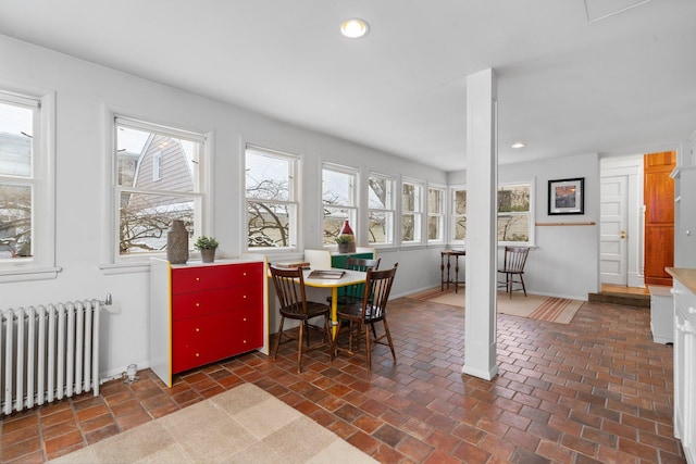 dining area featuring a healthy amount of sunlight and radiator