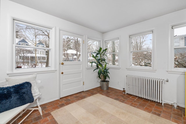 sunroom with radiator heating unit