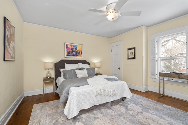 bedroom with crown molding, dark hardwood / wood-style floors, and ceiling fan