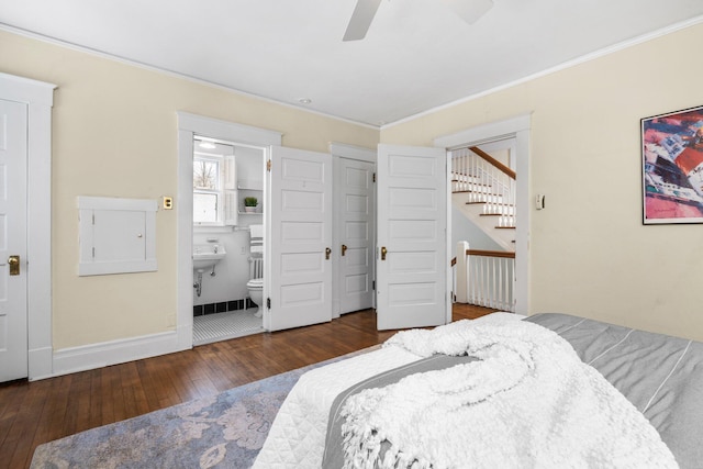 bedroom featuring dark wood-type flooring, ceiling fan, ornamental molding, and ensuite bath