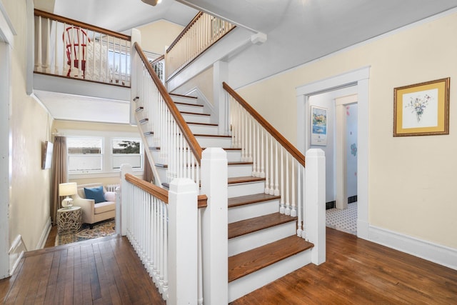 staircase with hardwood / wood-style floors