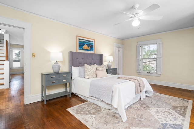 bedroom with multiple windows, crown molding, dark hardwood / wood-style flooring, and ceiling fan