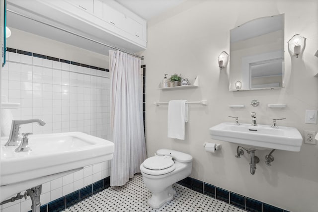 bathroom featuring walk in shower, sink, and toilet