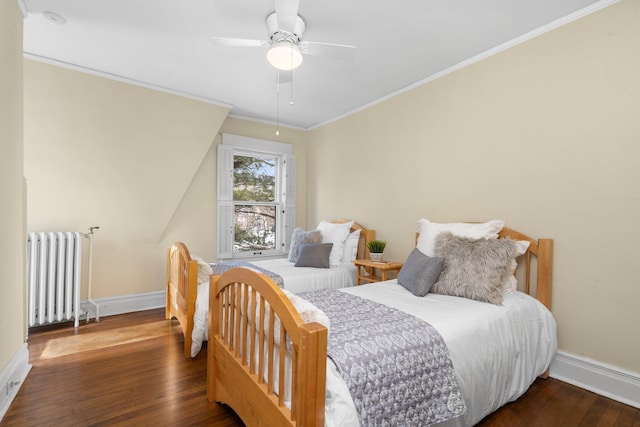 bedroom with dark hardwood / wood-style flooring, radiator, ornamental molding, and ceiling fan