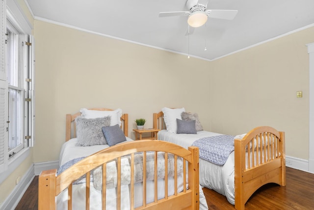 bedroom featuring dark wood-type flooring, ceiling fan, and crown molding