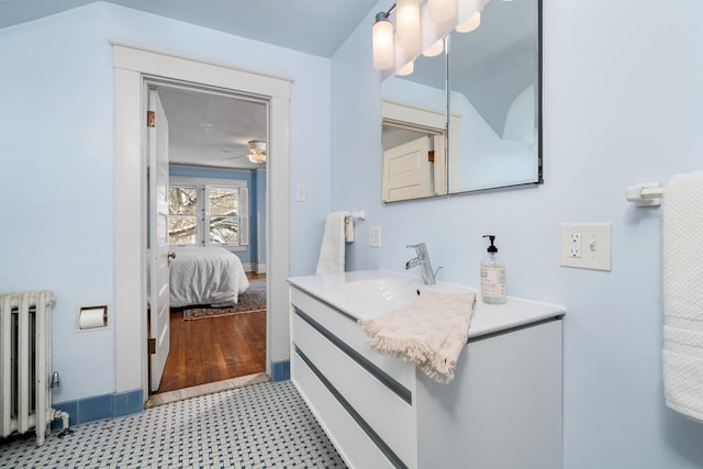 bathroom featuring ceiling fan, vanity, and radiator