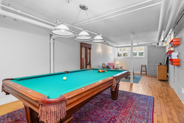 playroom with brick wall, pool table, and light wood-type flooring