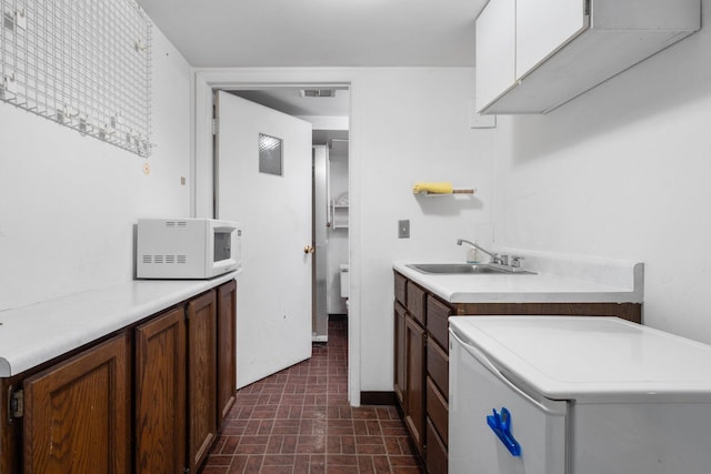 kitchen featuring sink and washer / dryer