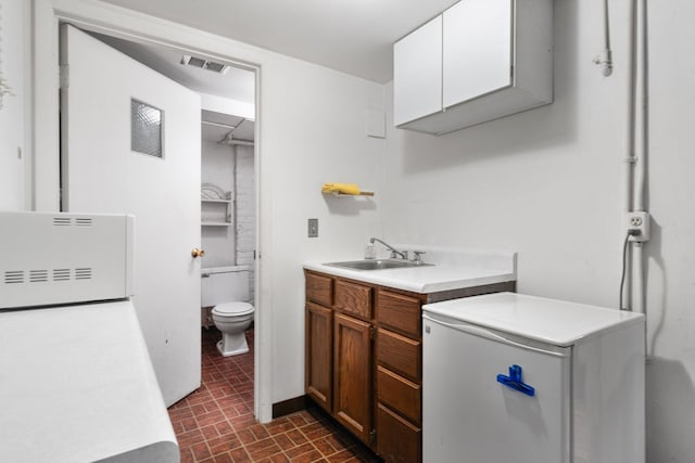 bathroom with vanity and toilet