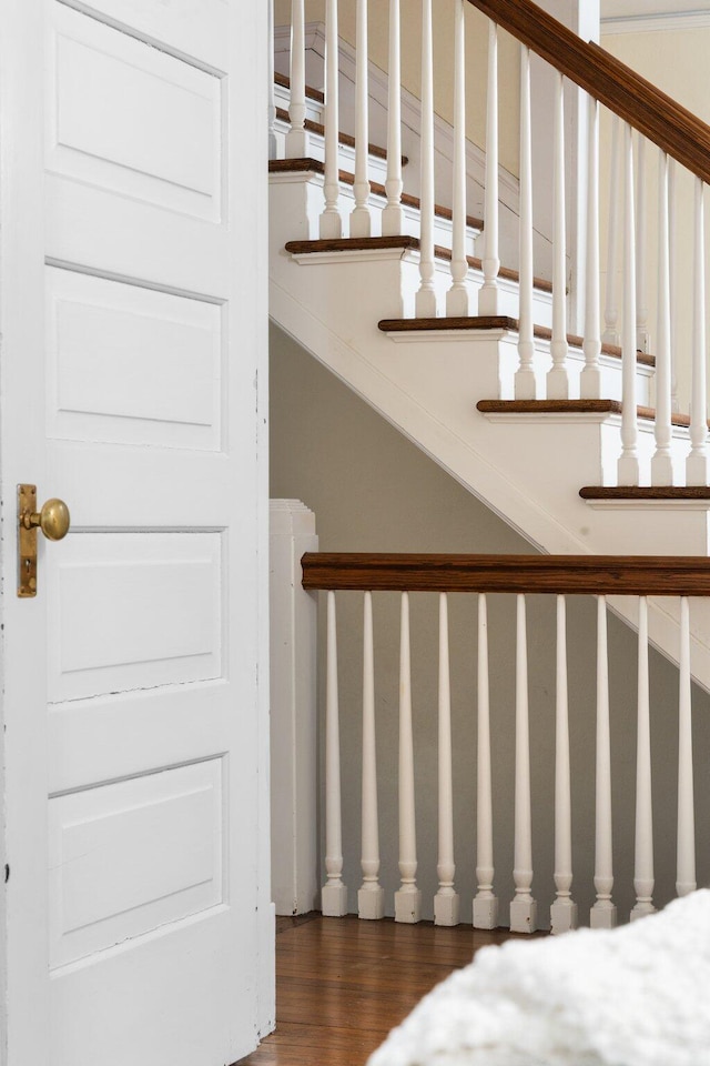 stairs featuring hardwood / wood-style floors