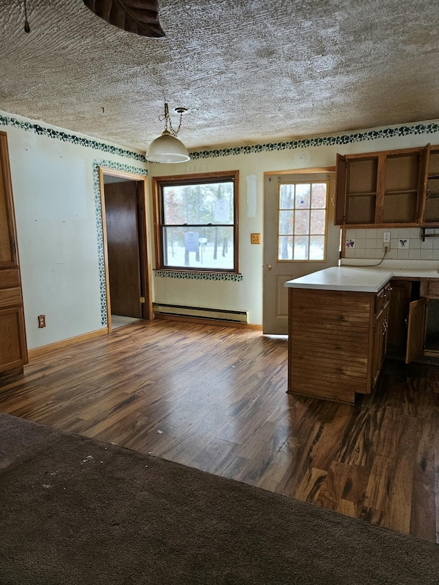 kitchen with backsplash, dark hardwood / wood-style floors, and baseboard heating