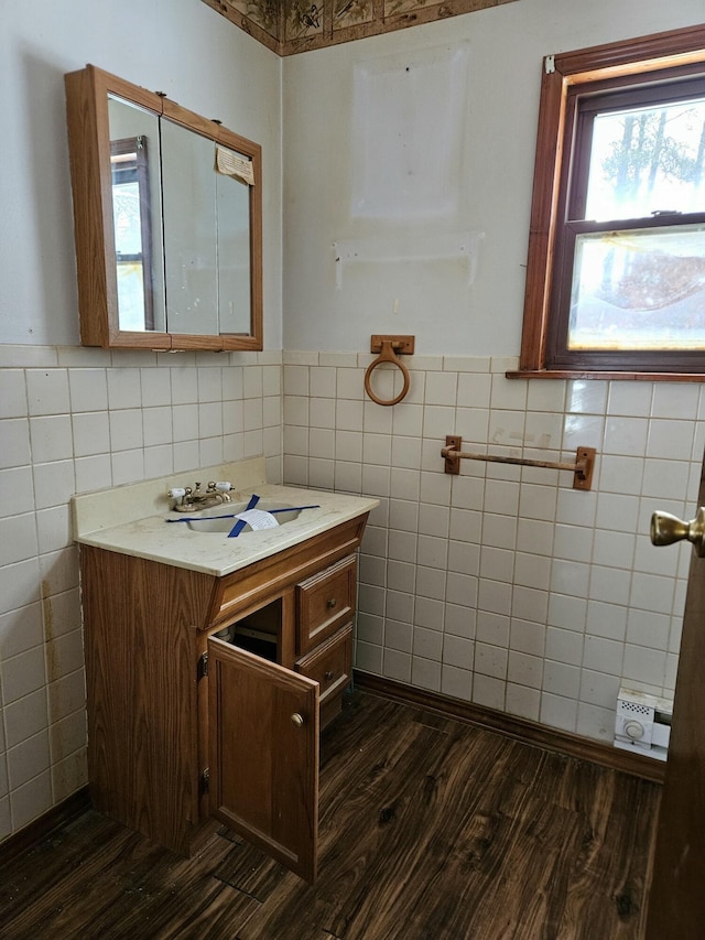 bathroom with vanity, hardwood / wood-style flooring, and tile walls