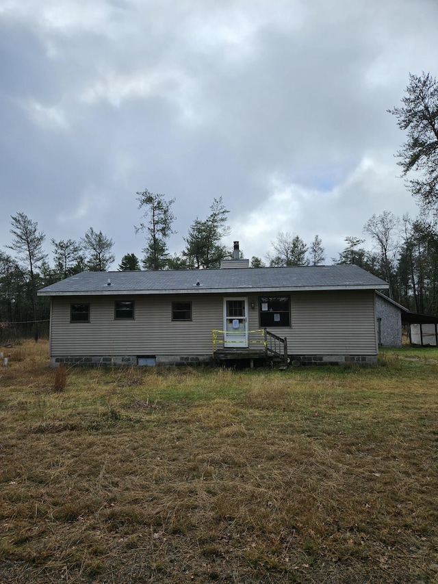 back of house with a lawn