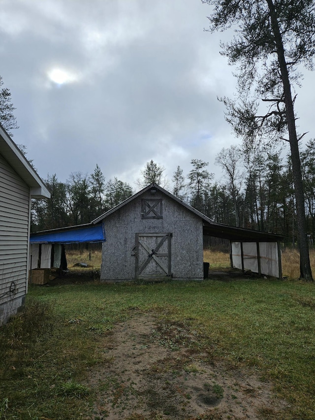 view of outbuilding with a yard