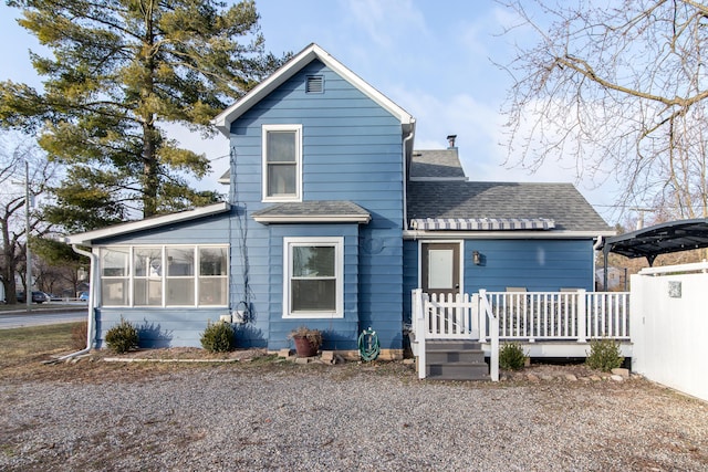 view of front of property with a deck and a sunroom