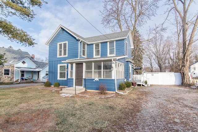 view of front of house featuring a front yard and a sunroom