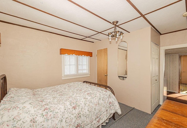 carpeted bedroom with an inviting chandelier