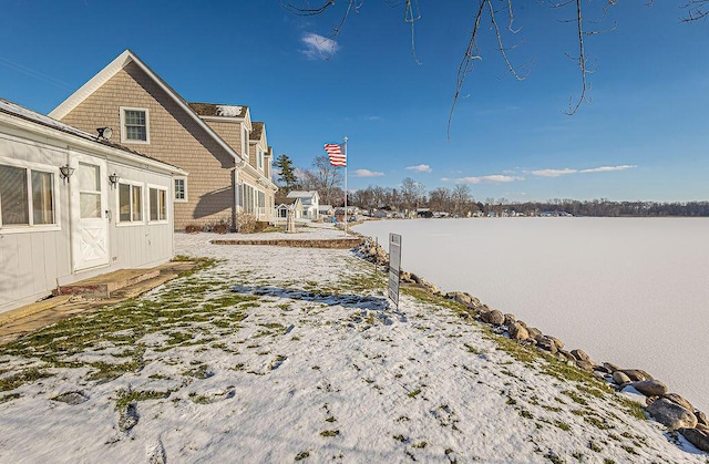 snowy yard with a water view