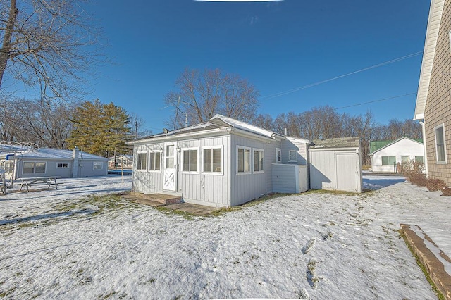 view of snow covered back of property