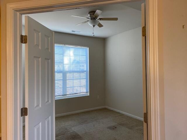 unfurnished room featuring carpet floors and ceiling fan