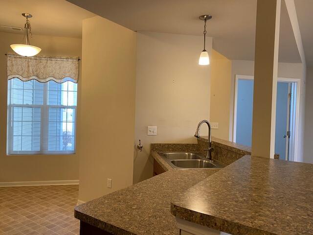 kitchen with decorative light fixtures and sink