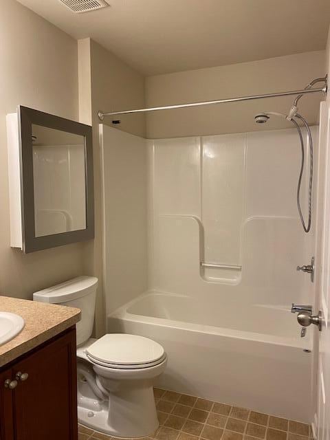 full bathroom with vanity, tub / shower combination, and toilet