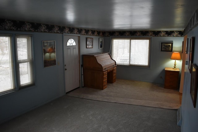 view of carpeted foyer entrance