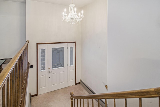 carpeted foyer featuring a baseboard heating unit and a notable chandelier