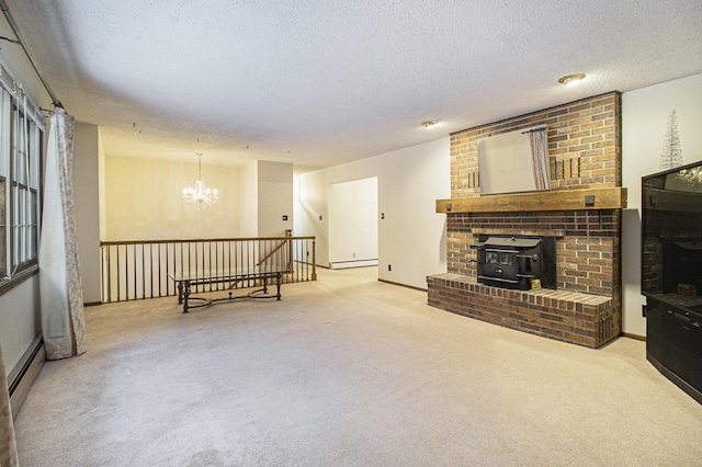 carpeted living room with a wood stove, a textured ceiling, a baseboard radiator, and a chandelier