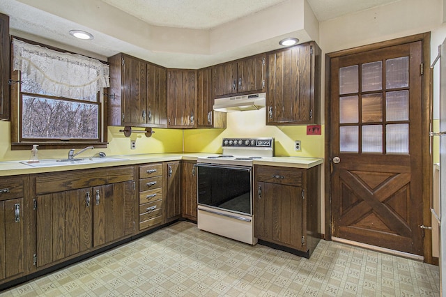 kitchen with dark brown cabinets, a textured ceiling, range with electric stovetop, and sink