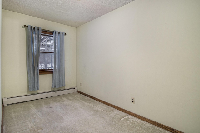 carpeted empty room featuring a textured ceiling and baseboard heating