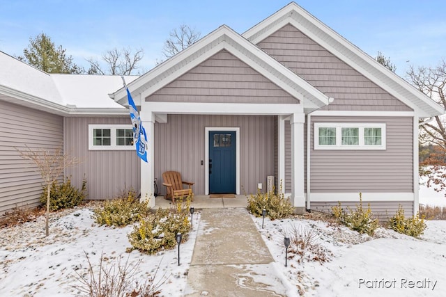 view of snow covered property entrance