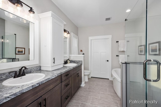 full bathroom featuring toilet, separate shower and tub, and vanity