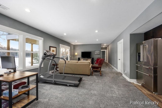 workout area featuring dark carpet