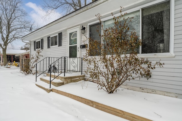 view of snow covered property entrance