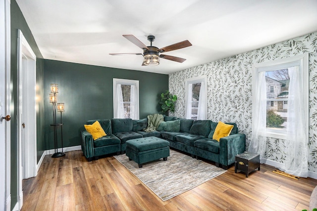 living room featuring wood-type flooring and ceiling fan