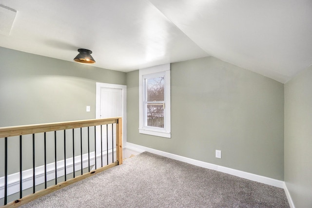 additional living space with vaulted ceiling and carpet